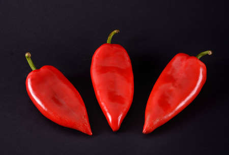 Red peppers on a black background. Ajvarの写真素材
