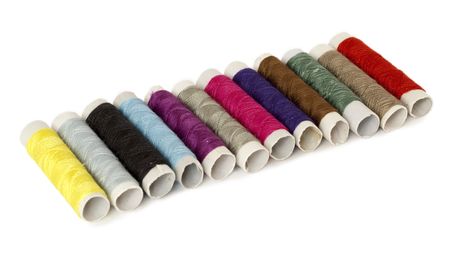 Set of colored spools of thread isolated on white