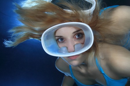 Female diver with orange dive mask の写真素材