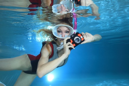 Sexy female snorkeler with underwater cameraの写真素材