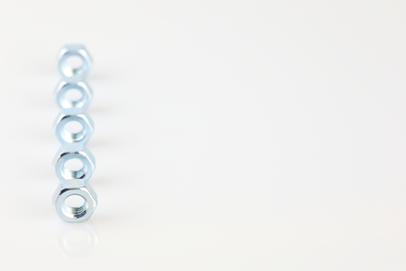 Metal screw nuts on white backgroundの写真素材