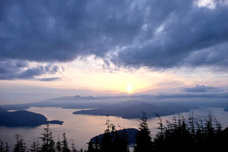 Cloudy sunrise over the ocean. View of Bowen Island from Bowen Lookout. Cypress Provincial Park, Vancouver, British Columbia, Canadaの写真素材
