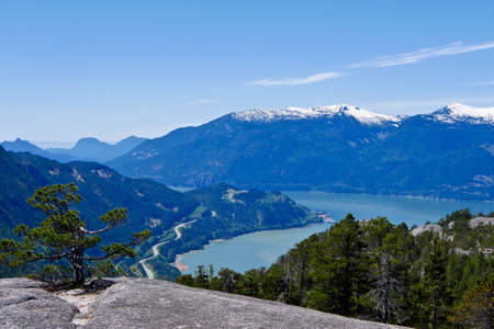 View of ocean and mountains from mountain top. Stawamus Chief Provincial Park near Squamish, British Columbia, Canada.の写真素材