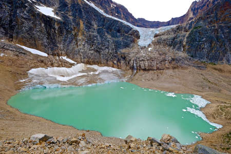 Green alpine lake and Angel Glacier. Edith Cavell Mount and lake. Jasper National Park. Canadian Rockies. Alberta. Canada.の写真素材
