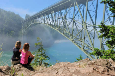 Group meditation by ocean in foggy morning. Deception Pass Bridge Park. Seattle. Anacortes. Washington. United States.の写真素材