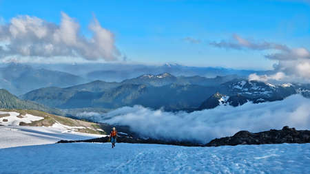 Man walking in mountains. Easton Glacier. Railroad Grade Trail. Mount Baker. North Cascades National...