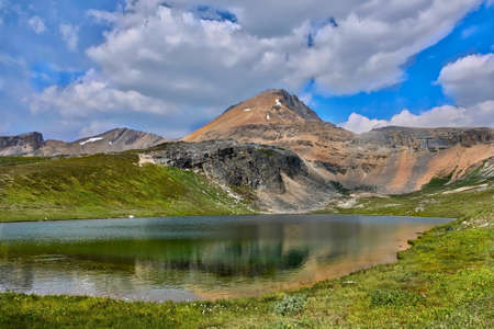 Little lake and reflection in Canadian Rockies. Cirque Peak and Helen Lake in Banff National Park in summer season.  Alberta. Canada.の写真素材