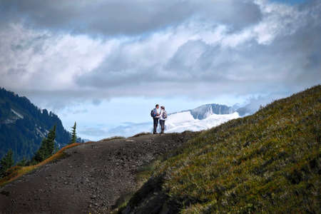 Young married couple hiking in mountains. Elfin Lakes trail in Garibaldi Provincial Park near...