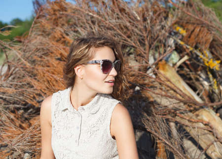Beautiful girl in sunglasses on a beach  Outdoor shootの写真素材