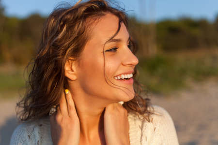 Beautiful curly girl is smiling  Outdoor shoot