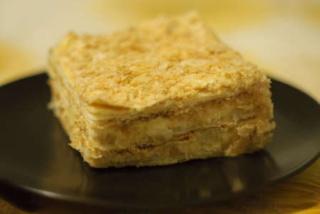 Tasty Napoleon cake on black plateの写真素材