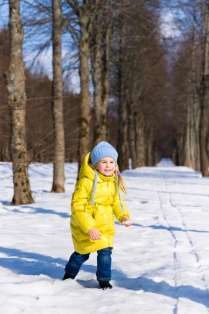 Funny little girl playing in winterの写真素材