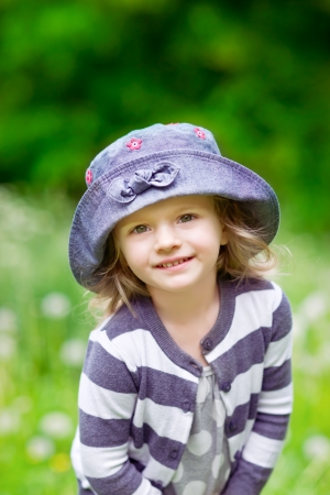 Adorable smiling little girl in summer fieldの写真素材