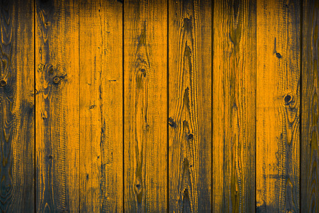 Old wooden yellow painted peeling off planks, texture backgroundの写真素材