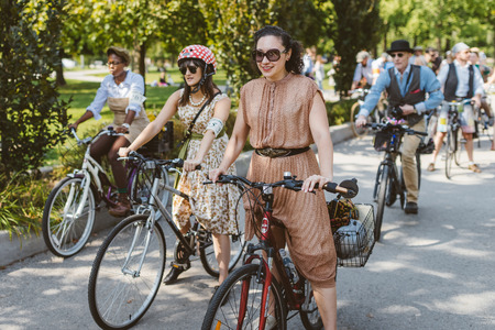 Toronto, Canada - September 20, 2014: Unidentified participants of Tweed Ride Toronto riding on their bicycles. This annual event also known as Tweed Run is dedicated to the style of old England: people dress up in vintage style clothes and try to reconstのeditorial素材