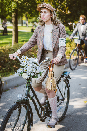 Toronto, Canada - September 20, 2014: Unidentified participants of Tweed Ride Toronto riding on their bicycles. This annual event also known as Tweed Run is dedicated to the style of old England: people dress up in vintage style clothes and try to reconstのeditorial素材