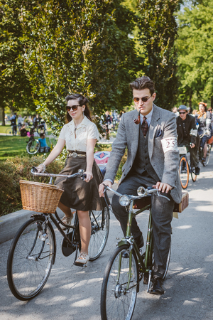 Toronto, Canada - September 20, 2014: Unidentified participants of Tweed Ride Toronto in vintage style clothes riding on their bicycles. This event is dedicated to the style of old Englandのeditorial素材