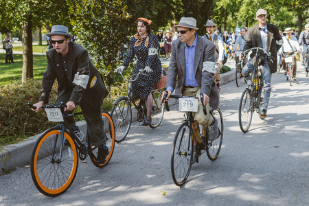 Toronto, Canada - September 20, 2014: Unidentified participants of Tweed Ride Toronto in vintage style clothes riding on their bicycles. This event is dedicated to the style of old Englandのeditorial素材