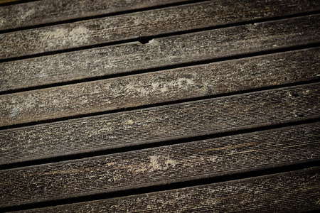 Wooden beach boardwalk with sand for texture or backgroundの写真素材