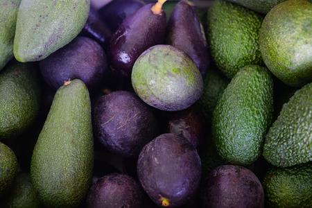 Sale, shopping, vitamins and eco food concept - ripe avocado at food market