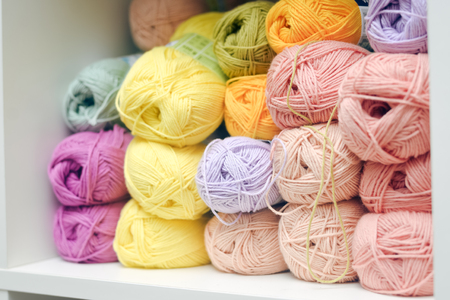 Colorful balls of wool or cotton yarn on shop shelf piled upの写真素材