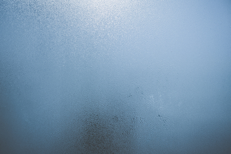 Closeup on fog condensation on window glass backgroundの写真素材