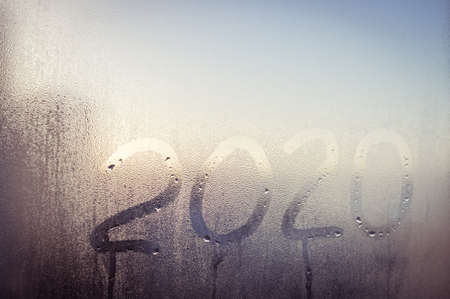 Happy 2020 New Year on window glass written text. abstract closeup texture backgroundの写真素材