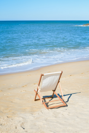 Back View Of Deckchair On Sandy Beach Vacation