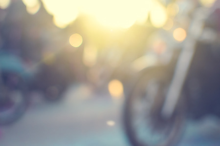 Defocused motorbikes riding on outdoors day road background sunny flareの写真素材