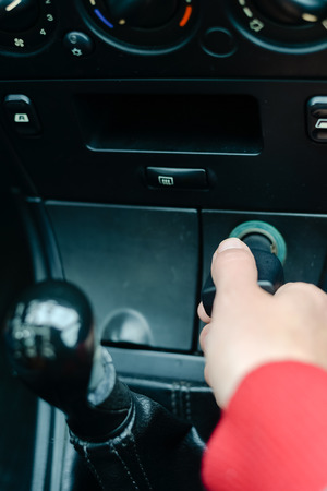 Closeup on hand of female and car phone chargerの写真素材