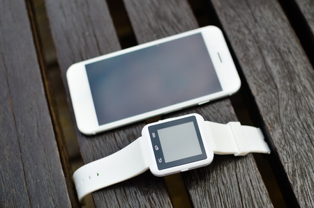 Hand smart watch smart phone, wooden surface outside background, Top view mock up flat lay design