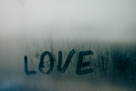 Love written sign on foggy window background. Attractive romantic messageの写真素材