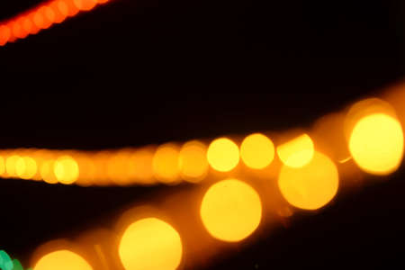 Abstract circular bokeh background of Christmas tree lights over dark background
