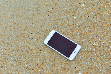 Closeup on smartphone on the beach background. Top view flat lay styleの写真素材