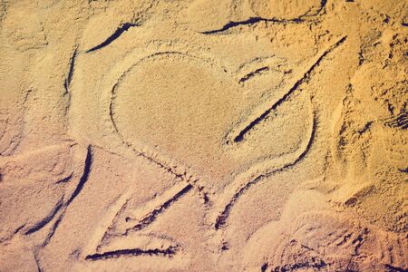 Love heart drawn in the sand on the atlantic coast