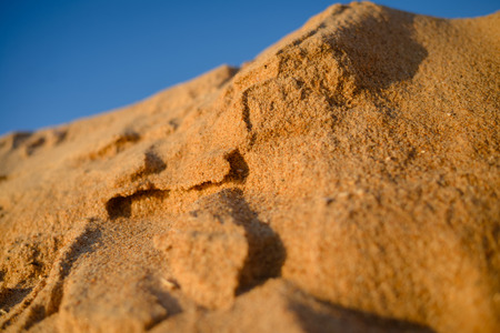 Desert, sandy barkhans over blue sky backgroundの写真素材