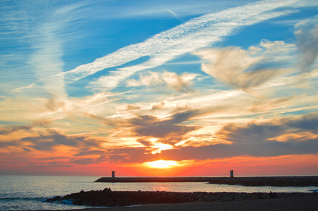 Beautiful wonderful golden seascape with a lighthouse at dawn backgroundの写真素材