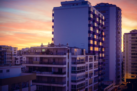 Modern buildings over dawn sky. City and sunrise sunset outdoors backgroundの写真素材