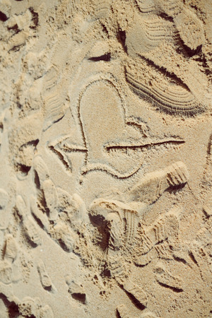 Love heart and arrow drawing in the beach sand outdoorsの写真素材