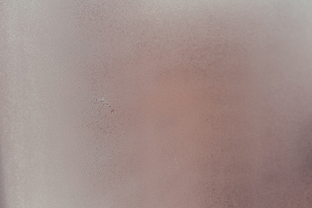 Closeup on fog condensation on window glass backgroundの写真素材