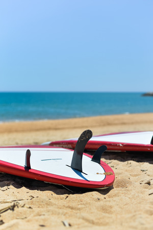 Ocean view, surfboard tail with three fins, blue sky backgroundの写真素材