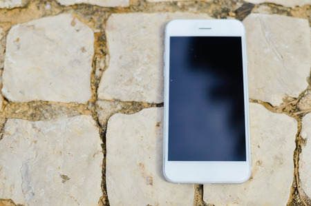 Mobile smart phone with blank screen, top view flat lay imageの写真素材