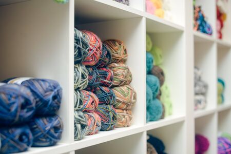 Knitting yarn on shelf, closeup photoの写真素材