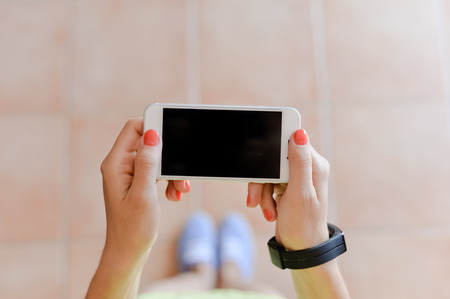 Closeup picture on hand using mobile smart phone, background of copy spaceの写真素材