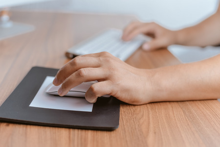 Closeup on person hands working typing, office desk background. Top view flat lay style