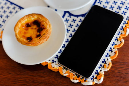 Cake with phone on table, top viewの写真素材