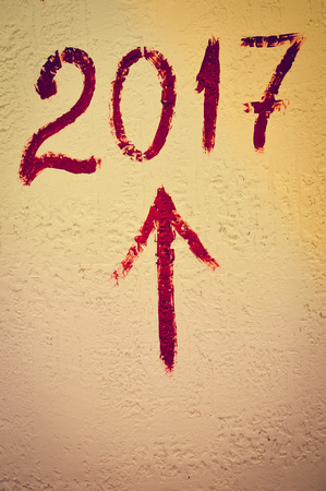 Sigh of Happy 2017 year written on light wall background, closeup