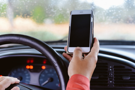 Hand hold use phone in car closeup