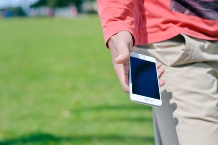Algarve, Portugal - March 23, 2016: Person holding iPhone 6 smartphone in hand pocket. Side view...