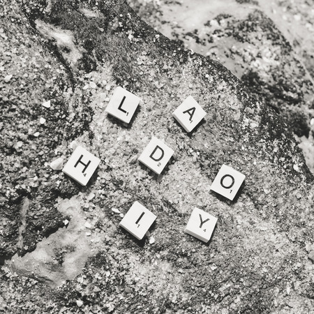 Top view on "Holiday" wooden sign pazzle abstract design on the beach backgroundの写真素材